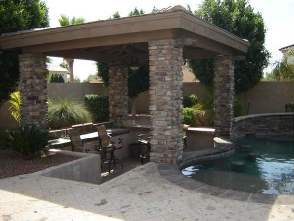 Poolside swim up seating for a sunken patio area with bar is sheltered ...