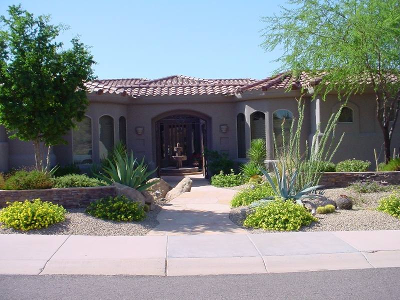 well balanced front yard design with stone walls and shrubs welcome 