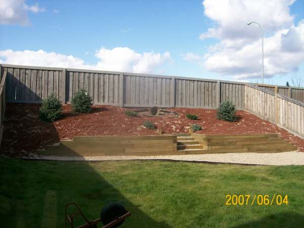  landscaping timbers. Fabric was applied to the hill and decorative