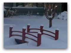 Small bridge provides a walkway over a dry river bed in the summer. Small structures like these often create interesting winter scenes.