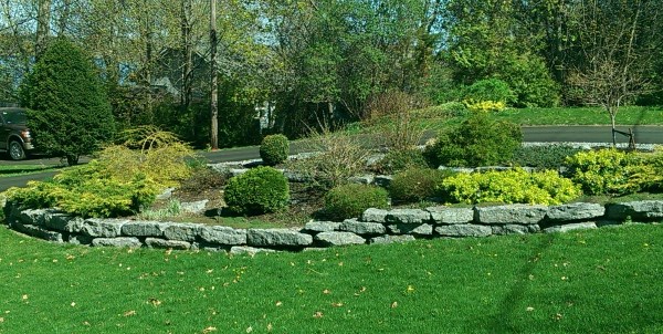 Large limestone blocks make for easy walls and nice garden borders while adding appeal to this large front yard.