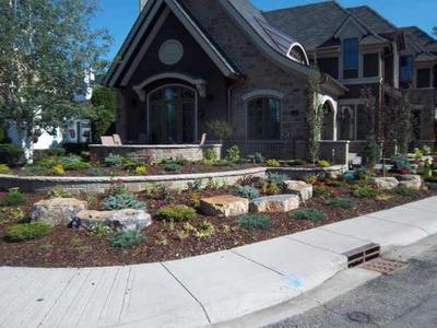 Making use of a corner lot with a house set back from the corner. Note how the stone wall flows with the sidewalk corner.