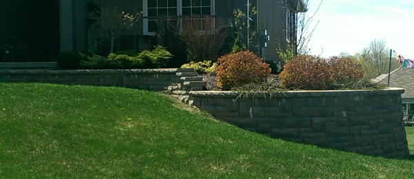 This front yard retaining wall extended the front entryway into a nice garden bed while avoiding a steep slope to mow.