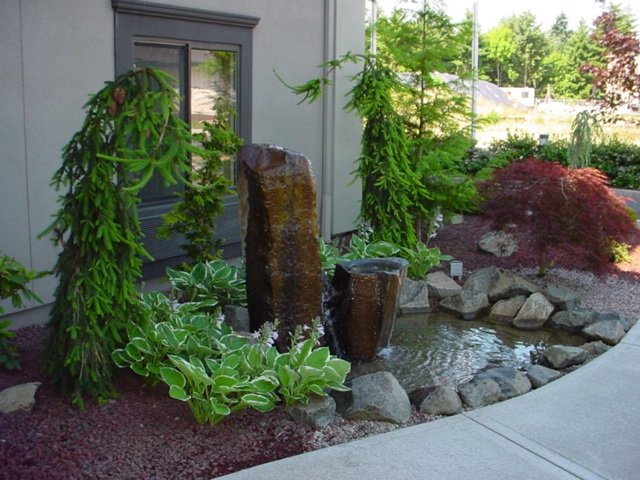 A bubbler welcomes people to this home along this front walkway.