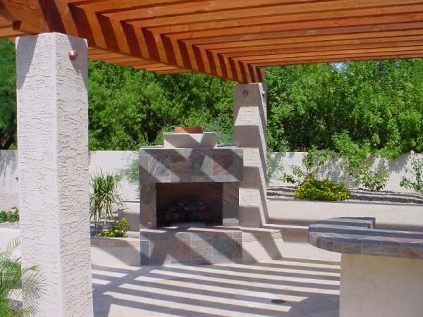 Outdoor fireplaces are becoming more and more popular, like this one situated just off this outdoor kitchen area.