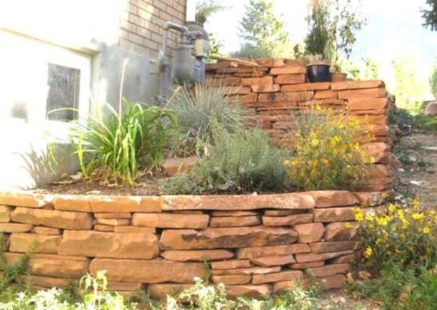 A steep corner is altered with a nicely stacked natural stone wall. 