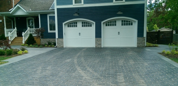 A nice brick Paver stone driveway that compliments the colours of the home. Formal square pavers also line each side of the driveway and lead to the front and back yards.