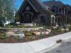 Making use of a corner lot with a house set back from the corner. Note how the stone wall flows with the sidewalk corner.