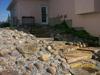 This slope of natural slab steps and a small boulder rock garden is a great way to have a low maintenance slope. 