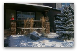 A small frontyard, designed for all seasons. Ornamental grasses and the feature boulders provide year round interest.