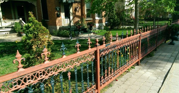 An old iron fence in need of repainting adds to the character.