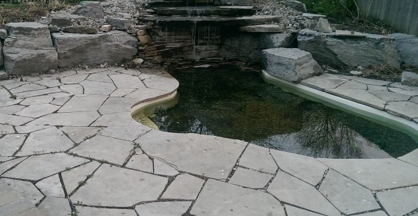 Back yard waterfalls provide more than just beauty. The sound of water has a therapeutic way of reaching the inner soul in all of us.