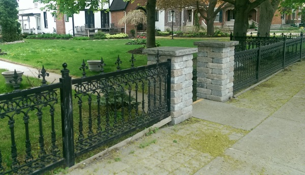 Fences found in older sections of town have such a classic an timeless look. The modern brick pillars actually tie in nicely with this old wrought iron fence.