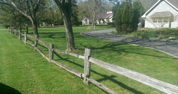 This simple wooden fence crossing multiple properties gives a country feel in an older section of a small town.