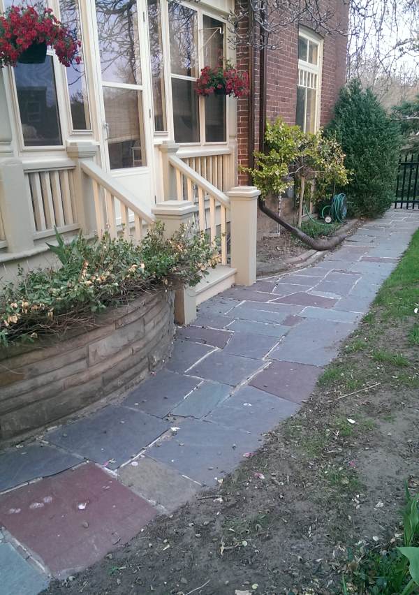 A nice flagstone walkway compliments this older home as it wrap around the side and into the back yard.