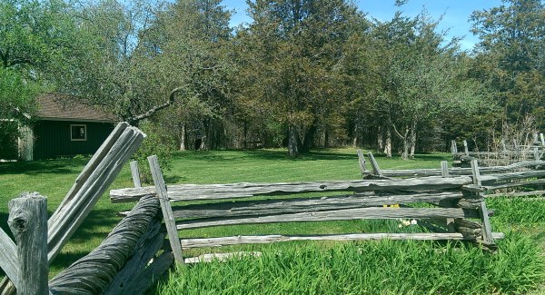 This rustic wooden split rail fence fits right in on this acreage country property.