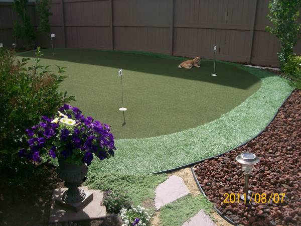 This artificial green is surrounded by a dark contrasting sea of decorative lava rock. 