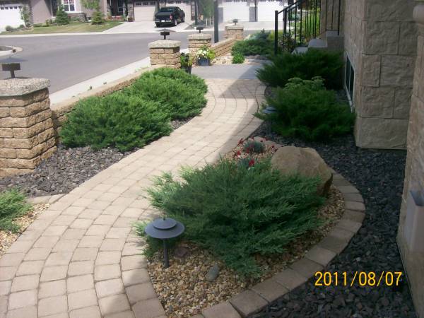 A manufactured brick walkway leading from the front of the house around to the backyard with nice gentle curves.