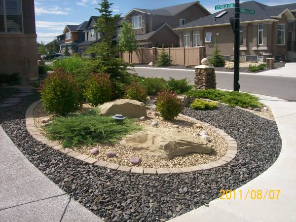 Driveway landscaping for a corner lot done with xeriscaping. 