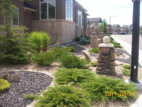 Xeriscaping a front yard with two contrasting decorative rocks.