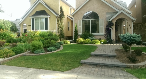 Landscaping between houses is the best example you will find of landscaping themes that visually fight each other because they lack a barrier or separation. Do these 2 designs work?