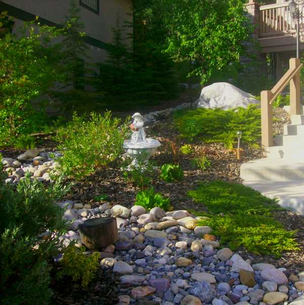 This design shows how a steeply sloping front yard can be tamed without using retaining walls.