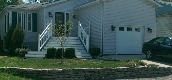 A low fieldstone wall is a great way to dress up a home with a sloping front yard. You can tell by the way these stones were so tightly fitted that it was built with great skill.