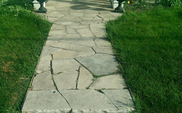 A short flagstone walkway leads to a small patio opening at the front door.