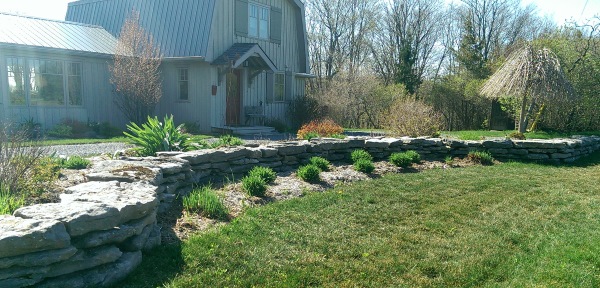 This front yard added a dry stacked low fieldstone decorative wall that fits right in the country setting it's in.