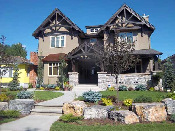 The large rocks and tree used here add needed height to this front yard landscaping design.