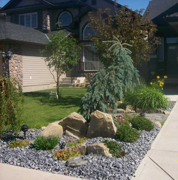 Attractive driveway landscaping for a small front yard. 