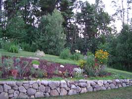 This natural stone wall creates a more gentle slope. 