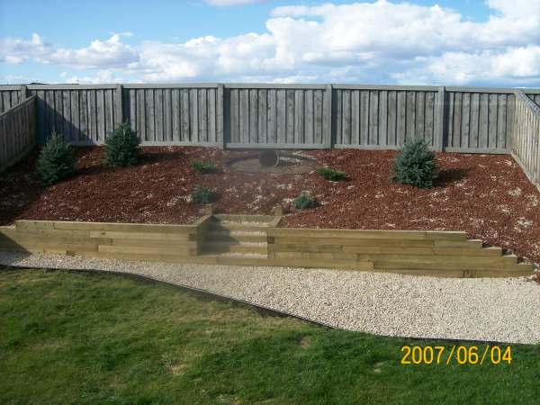 This slope was covered with landscape fabric and planted with some drought tolerant shrubs before being topped with decorative rock.