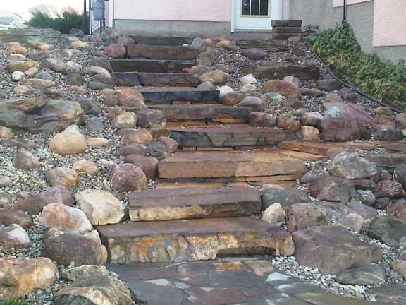 This newly completed project is waiting for shrubs to add some colour. These natural stone slab steps and rock garden, replaced a steep, slippery, and often muddy hill.