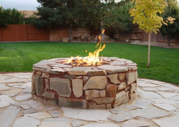 A dry creek bed comes from down the side of the house and splits this front yard, breaking up the sea of gravel. 