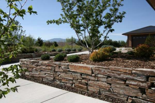 Wallstone is used here to line the driveway and support raised beds on both sides.