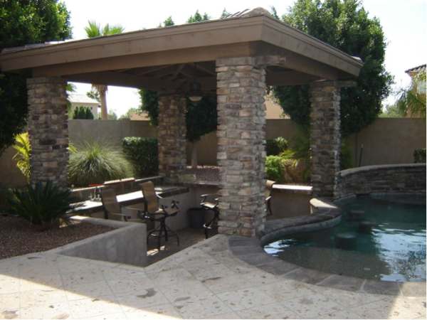 Poolside swim up seating for a sunken patio area with bar is sheltered from the hot sun.