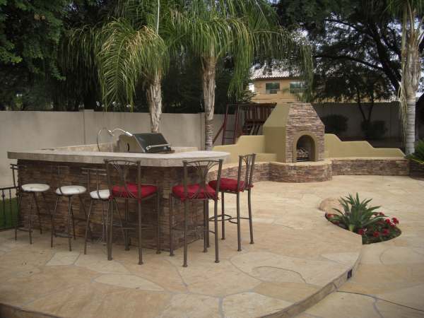 A flagstone patio creates a nice floor for this outdoor kitchen area and fireplace.