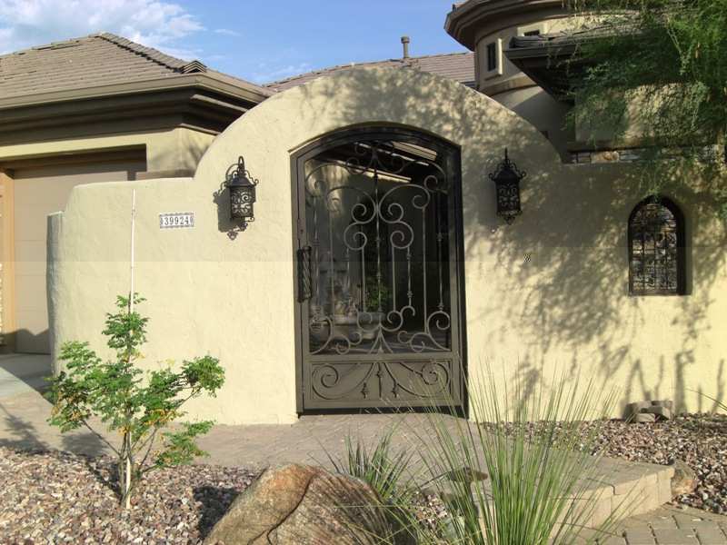 Brick steps and a short brick walkway lead to this gate and courtyard.