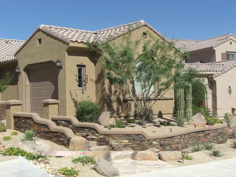 These front steps lead to a beautiful gated entryway for a desert courtyard.