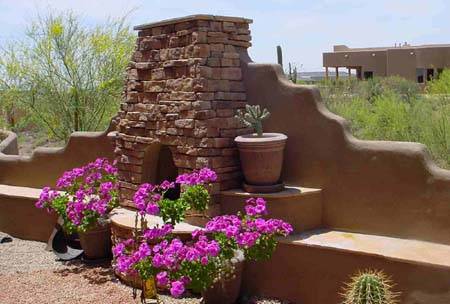 An outdoor fireplace feature provides height and a little privacy to this backyard.