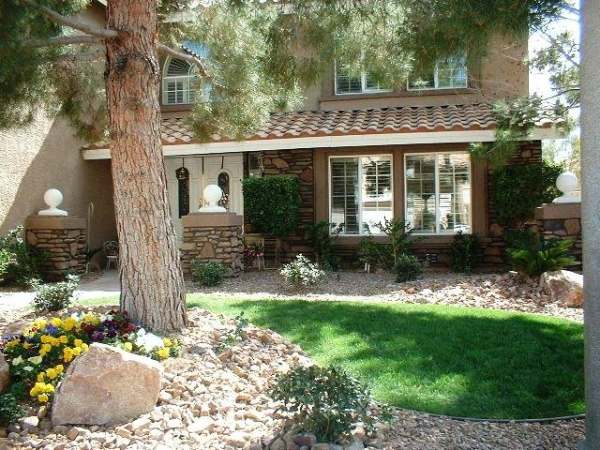 What may have been a plain, flat yard has been transformed with rock, shrubs and just the right amount of lawn.