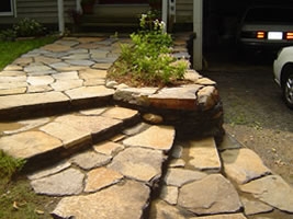 With the driveway lower than the front door, this retaining wall and flagstone front walkway were a nice addition. 