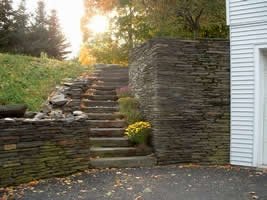 These stone steps and retaining walls tame a very steep slope.