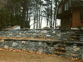 This multi level flagstone wall with fieldstone mixed in at various spots, has tons of character.