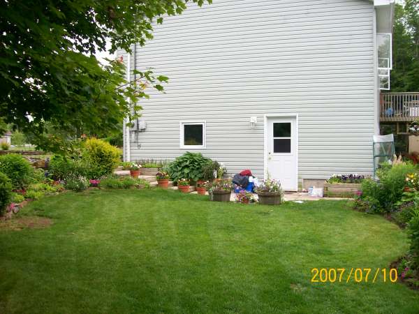 Having a lawn bordered by flower beds, gives this yard colour and interest in every direction.