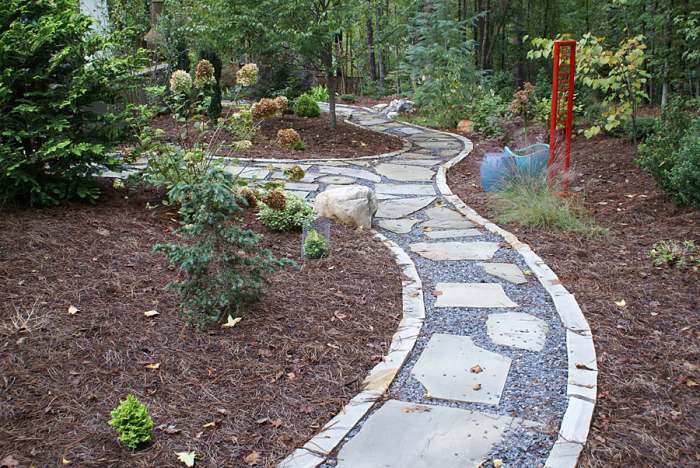 Weaving narrow walkways of flagstone are bedded in crushed rock.