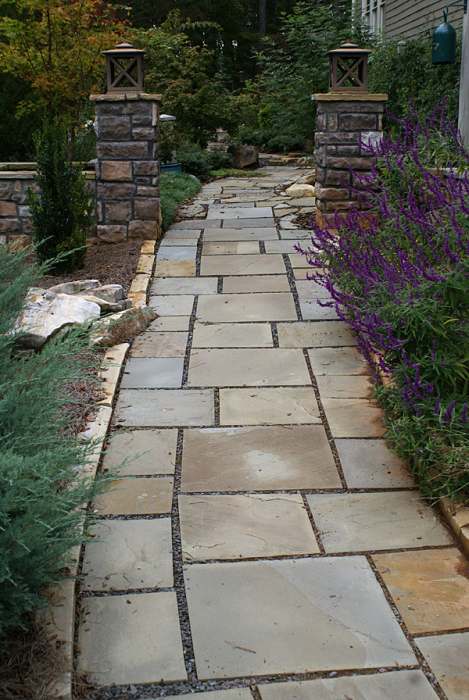 A formal front walkway with some creativity. Notice on the left the way the formal cut stones were built around what appears to be a small outcropping of rocks.