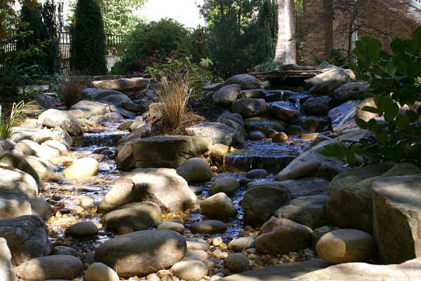 Small boulders mixed with rocks that look like natural outcroppings.