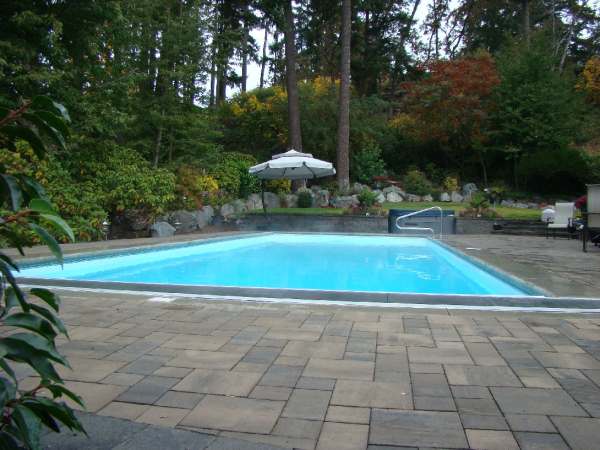 Privacy built from a natural backdrop of green space gives this formal pool area lots of appeal.